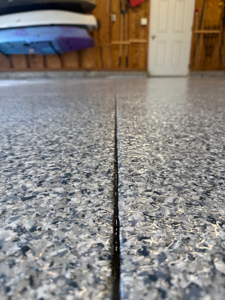 After coating: close-up of finished flake floor seam.