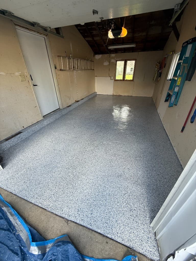 Finished single-car garage floor in Tidal Wave flake coating.