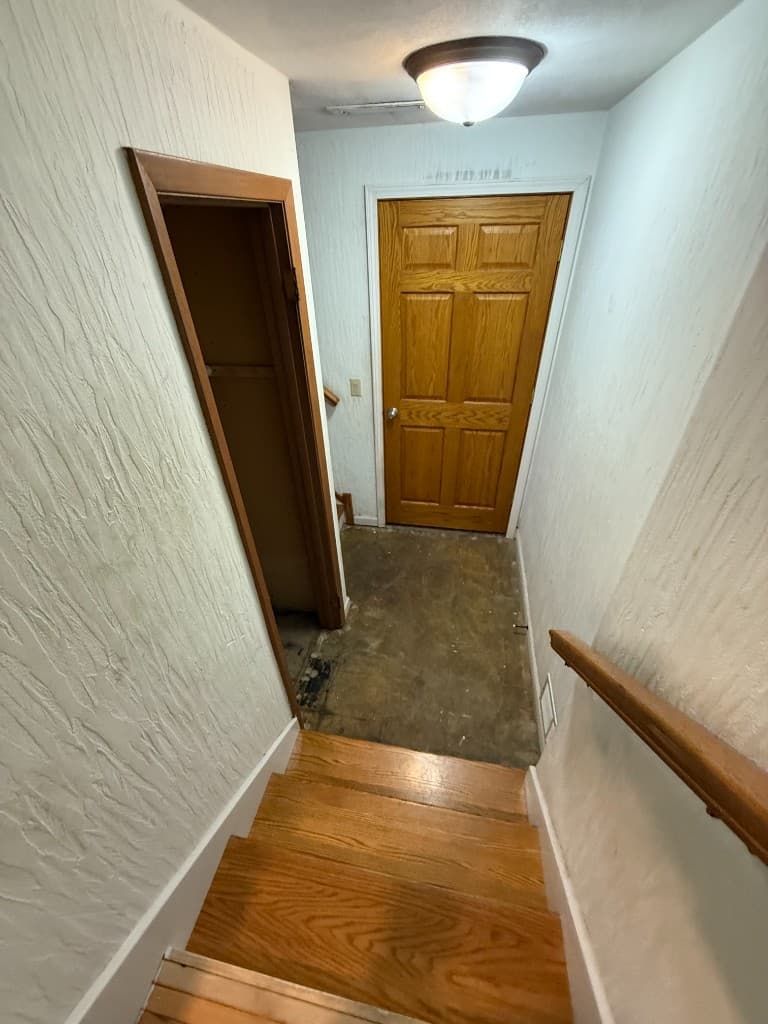 Bare concrete stair landing before coating.